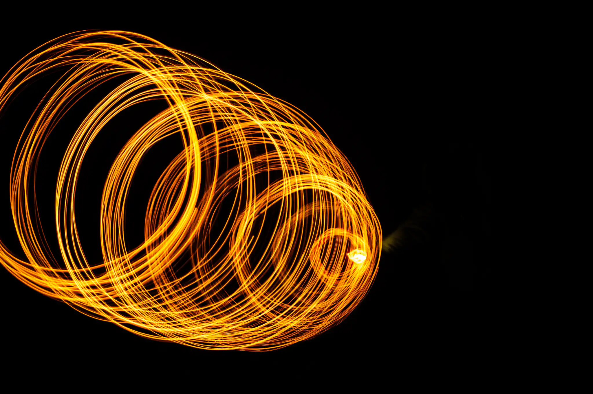 Glowing orange fire spiral lines abstract