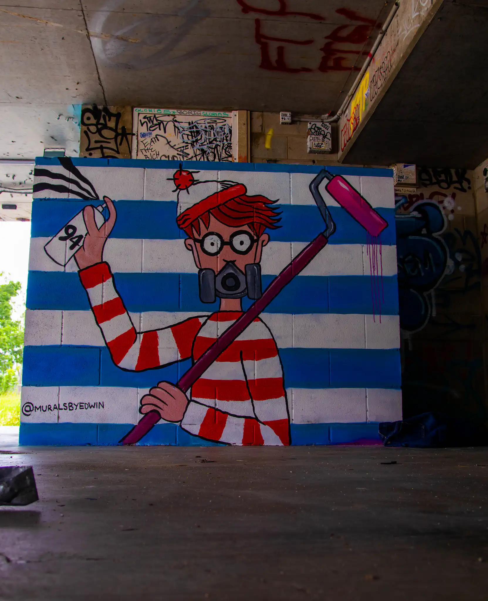 Colorful mural of Wheres Walley character with paint roller